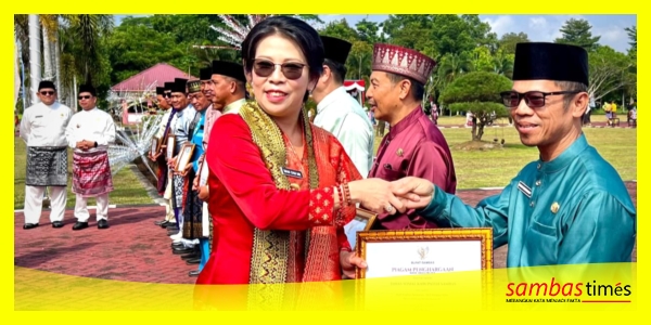 Walikota Singkawang, Tjhai Chui Mie menyerahkan Piagam Penghargaan dari Bupati Sambas atas penilaian kualitas baik tahun 2025 oleh Ombudsman RI, di Halaman Kantor Bupati Sambas, Rabu (15/7/2026).